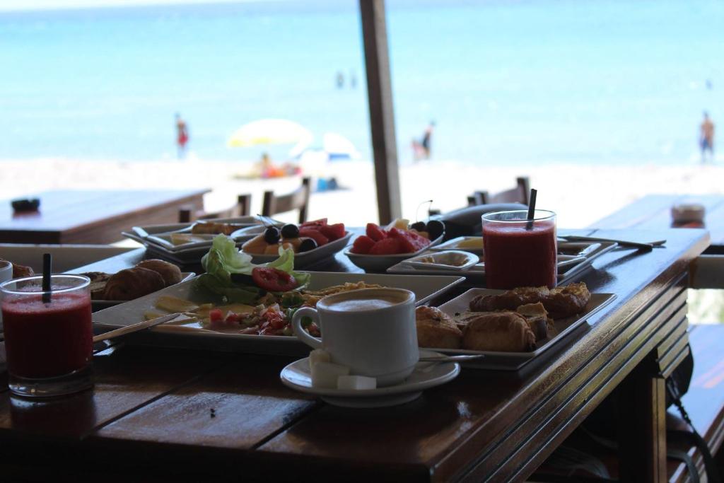 a table with a tray of food on a table at the beach at otel denizyıldızı in Fethiye