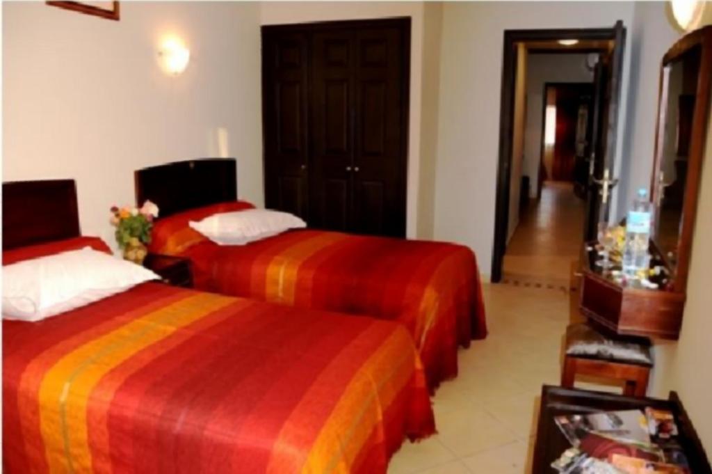 Postel nebo postele na pokoji v ubytování Residence Hotel Assounfou