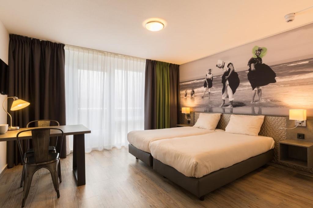 Postel nebo postele na pokoji v ubytování Strandhotel Bos en Duin