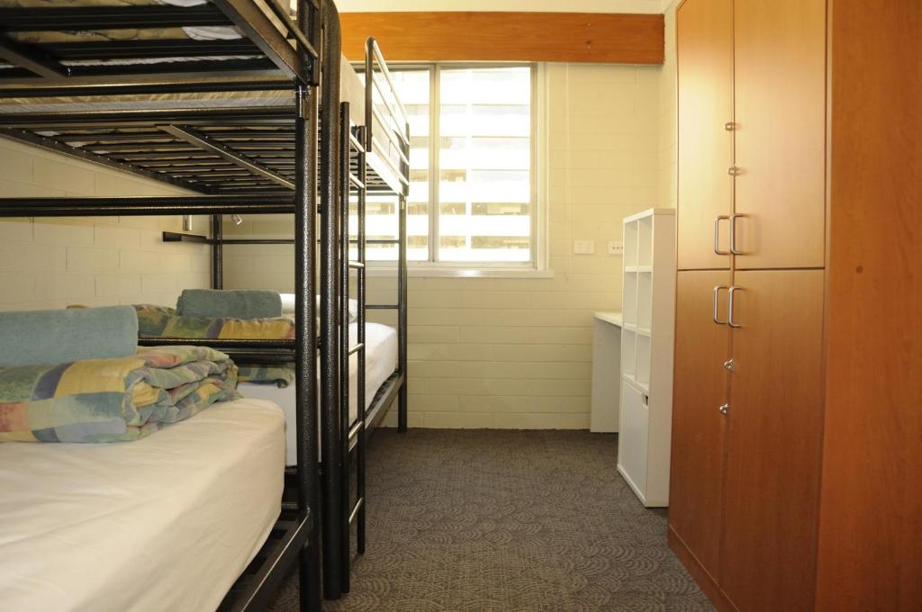 a room with three bunk beds and a window at Kangaroo Inn in Perth