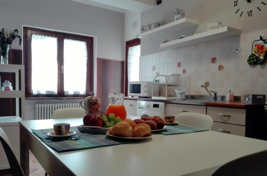 a kitchen with a table with a plate of fruit on it at Maison Teresa CIR 0161 in Aosta