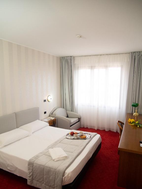 Posteľ alebo postele v izbe v ubytovaní Hotel Tessarin