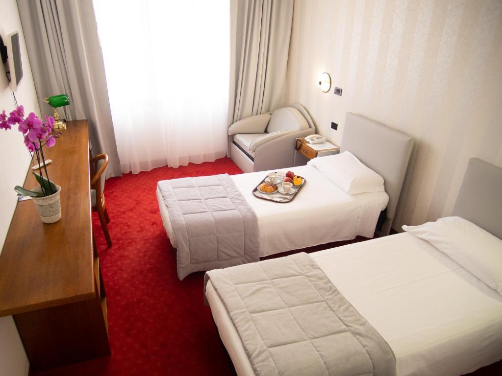 Posteľ alebo postele v izbe v ubytovaní Hotel Tessarin