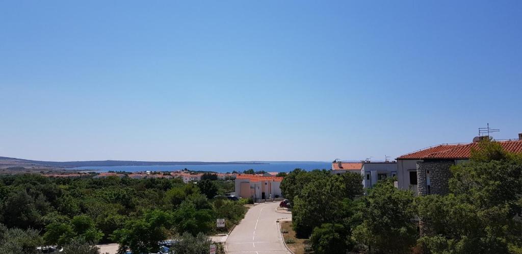 a view of a city with trees and a road at Apartmani Ruža in Novalja