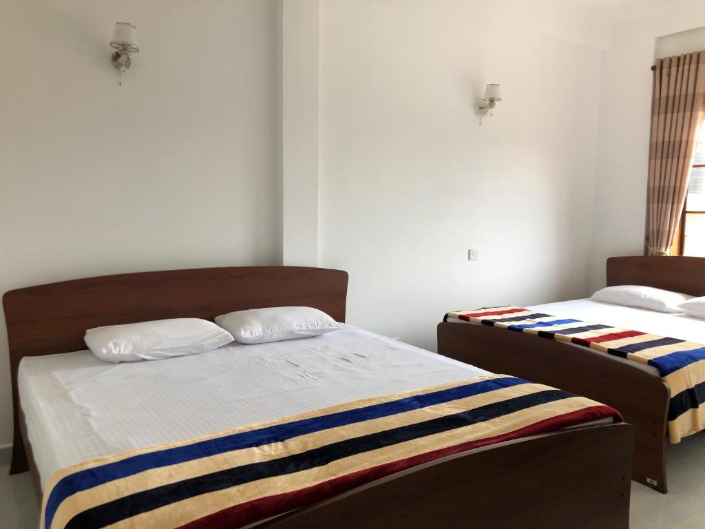 Postel nebo postele na pokoji v ubytování Gimhana Guest House