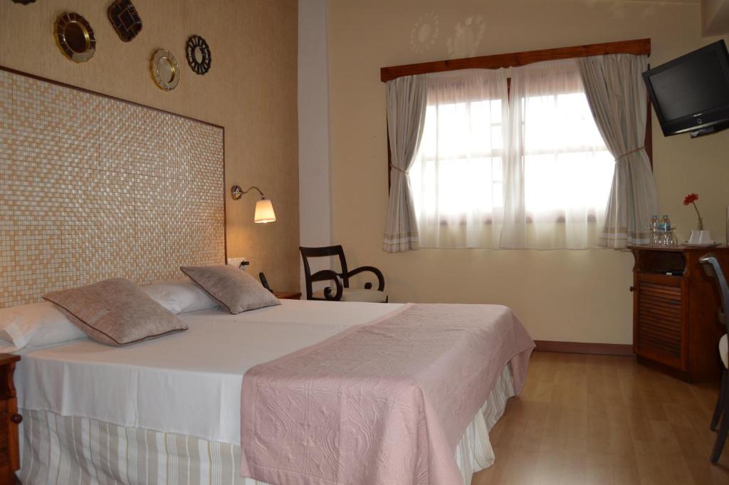 Postel nebo postele na pokoji v ubytování Gara Hotel
