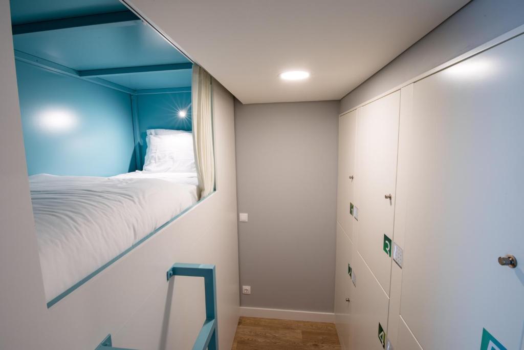 Postel nebo postele na pokoji v ubytování Ilha Hostel & Suites