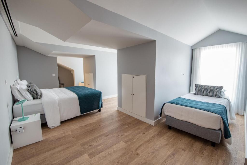 Postel nebo postele na pokoji v ubytování Ilha Hostel & Suites
