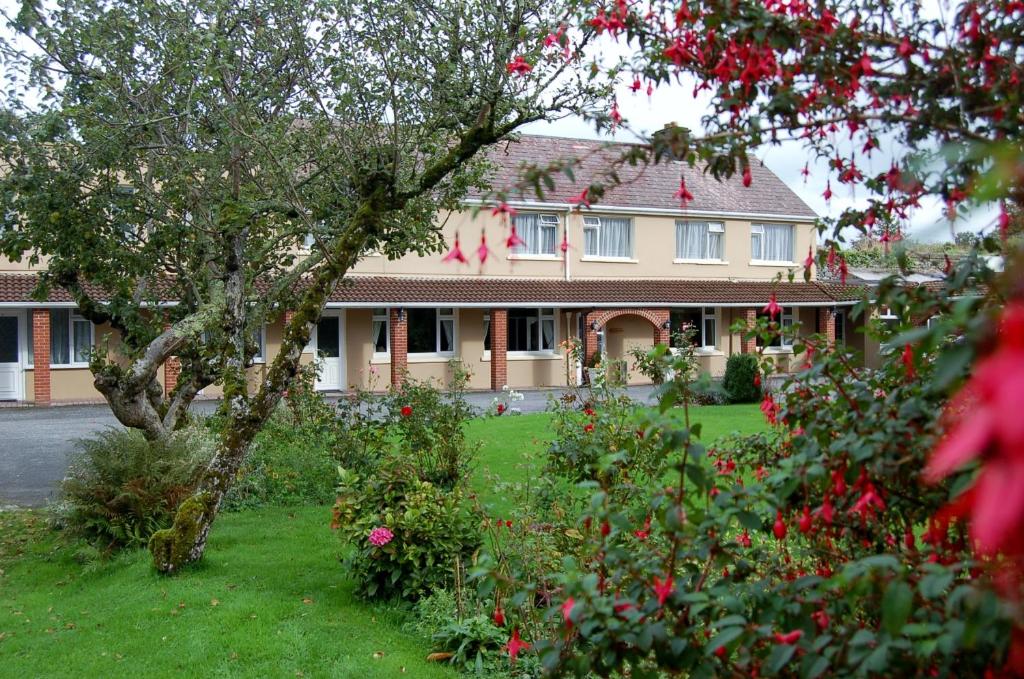 a large house with flowers in front of it at The Gardens guest accommodation in Killarney