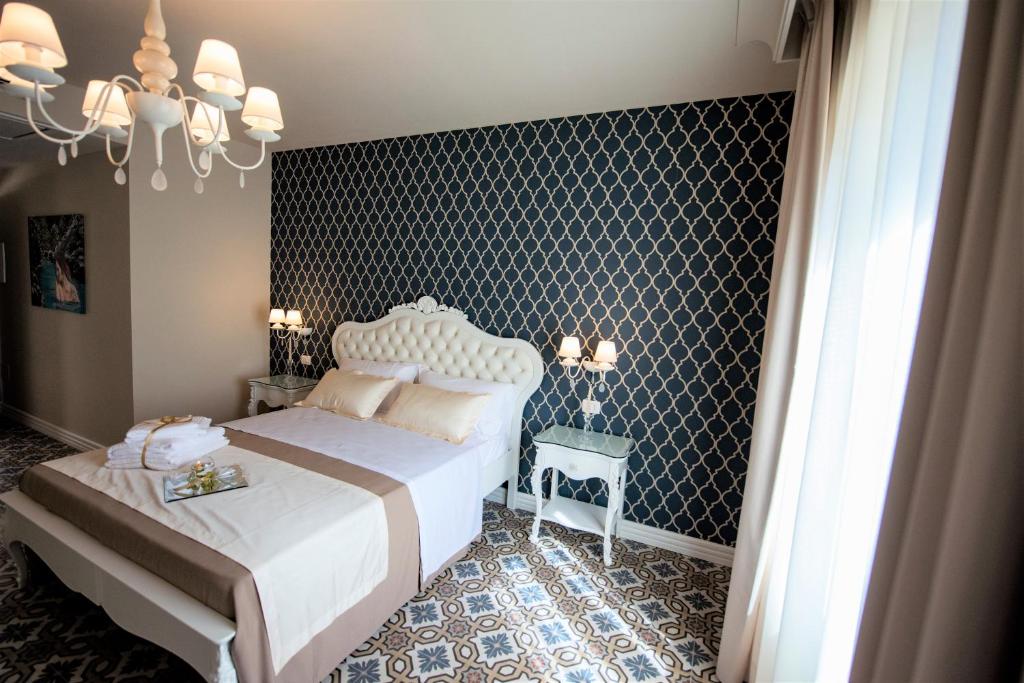Postel nebo postele na pokoji v ubytování Sui Generis Tropea Luxury Rooms