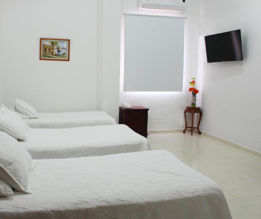 Postel nebo postele na pokoji v ubytování Hotel Dorado Plaza Centro Histórico