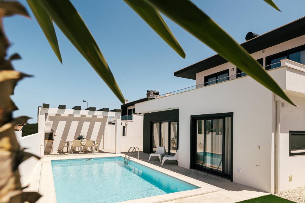 eine Villa mit einem Pool und einem Haus in der Unterkunft Obidos House with private pool in Bairro