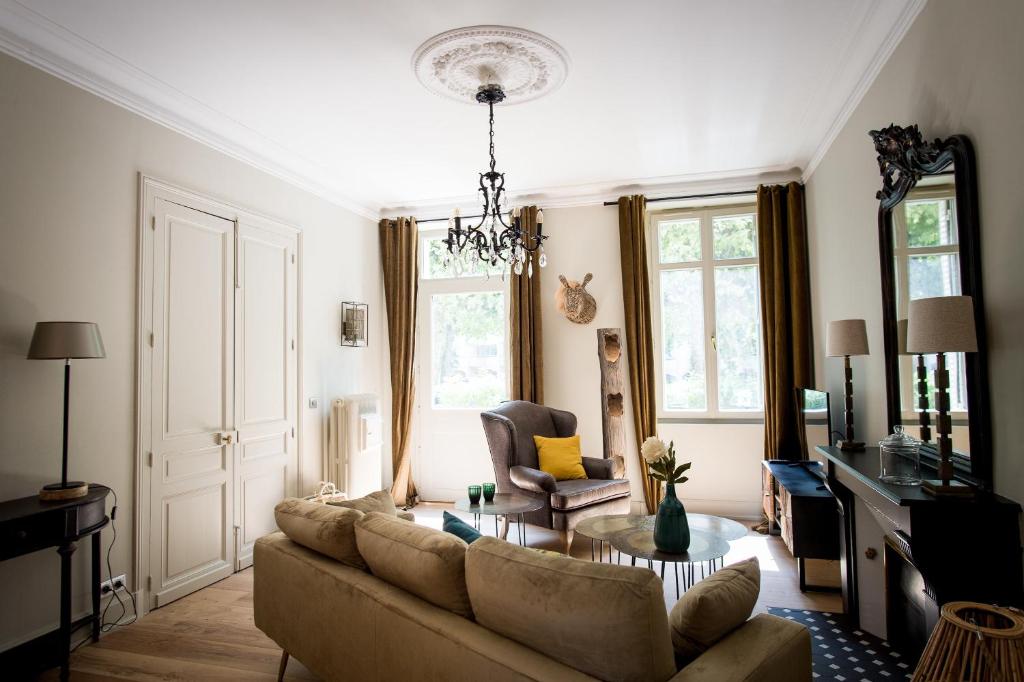 a living room with a couch and a table at La Suite d'Elisabeth in Sarlat-la-Canéda