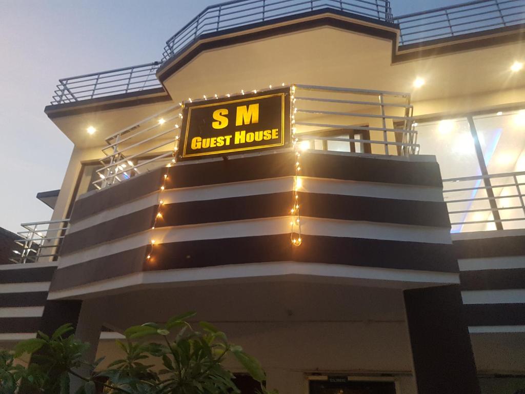 a building with a sign that reads s m guest house at SM Guest House in Lucknow