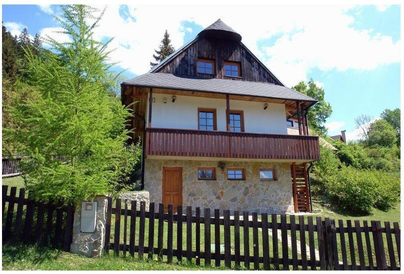 a large house with a fence in front of it at Chata 23 in Turčianske Teplice