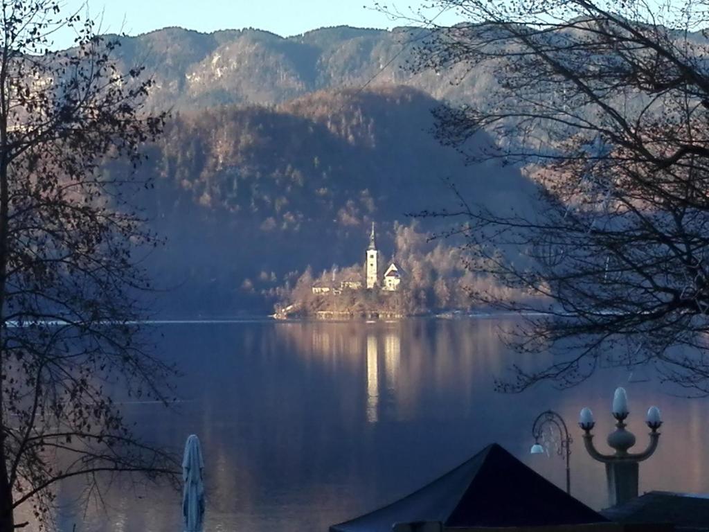 a castle on an island in the middle of a lake at APARTMA CARNICA in Bled
