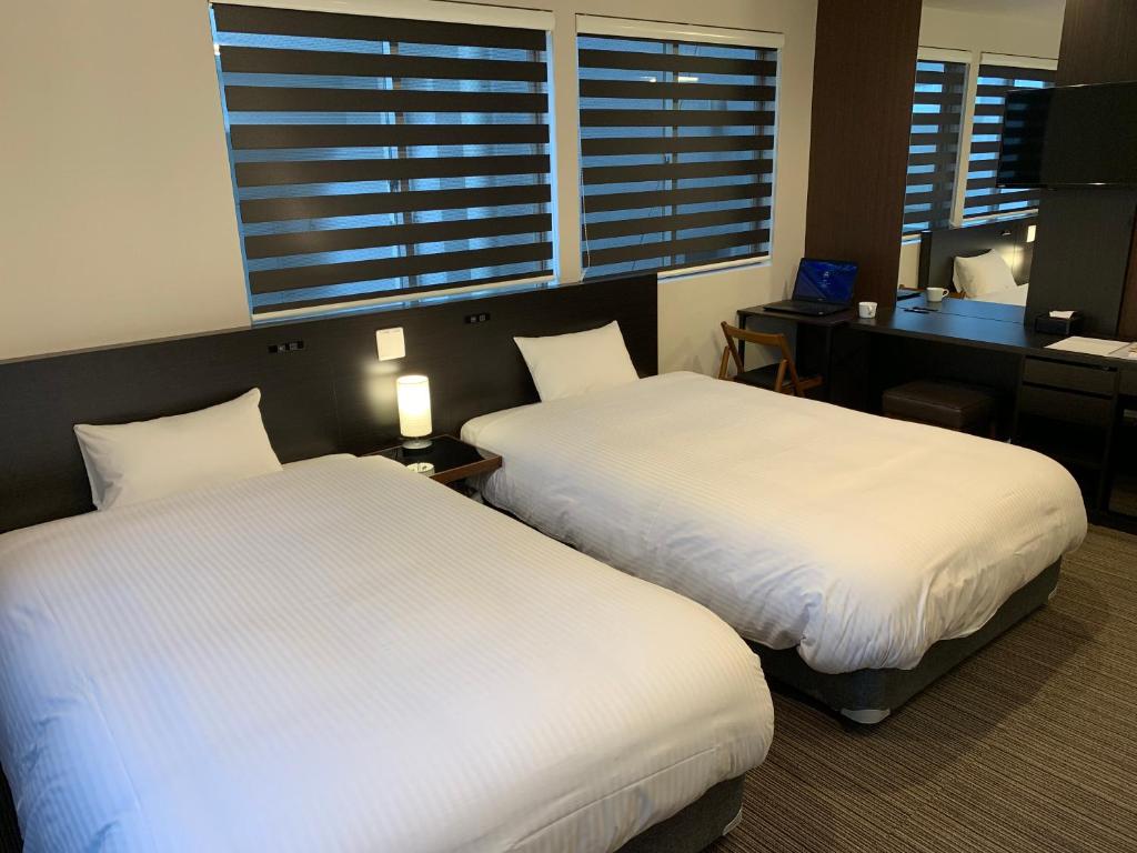 Postel nebo postele na pokoji v ubytování Hotel Kojan