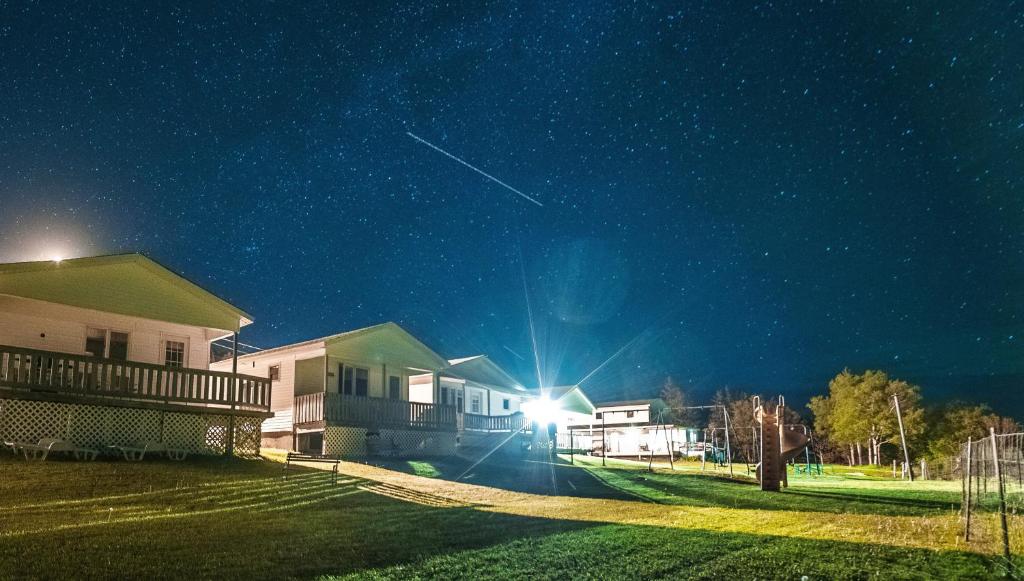 a group of houses at night with a starry sky at Codroy Valley Cottage Country 