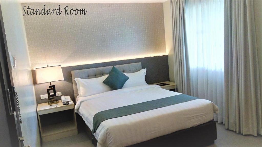 Postel nebo postele na pokoji v ubytování J7 Hotel