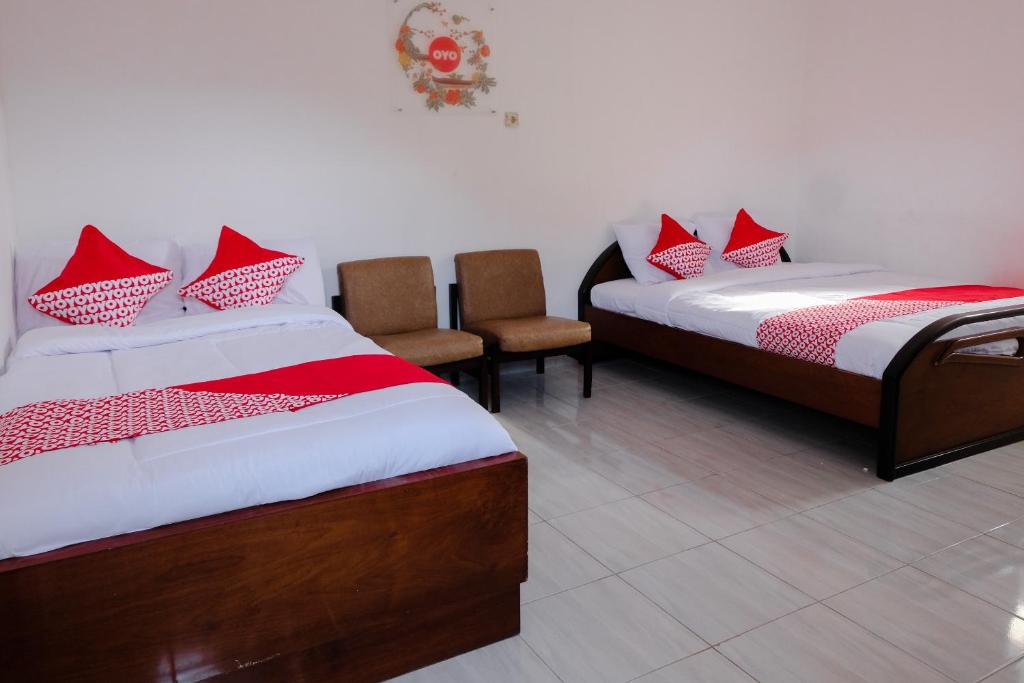 Postel nebo postele na pokoji v ubytování Super OYO Capital O 1176 J3 Residence Syariah