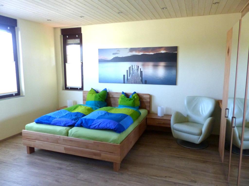 a bedroom with a bed and a chair in it at Ferienwohnung Stadtoase in Wittenberg in Lutherstadt Wittenberg