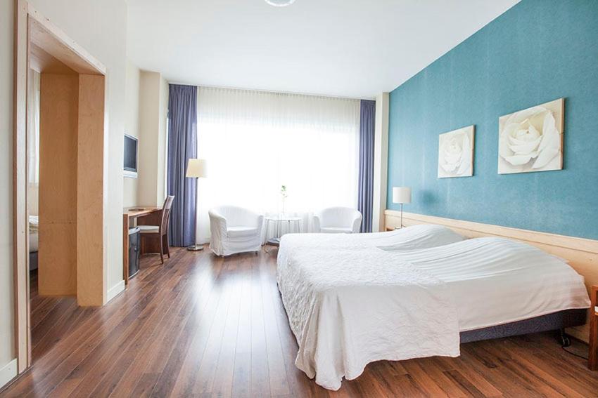 Postel nebo postele na pokoji v ubytování Hotel Gevers