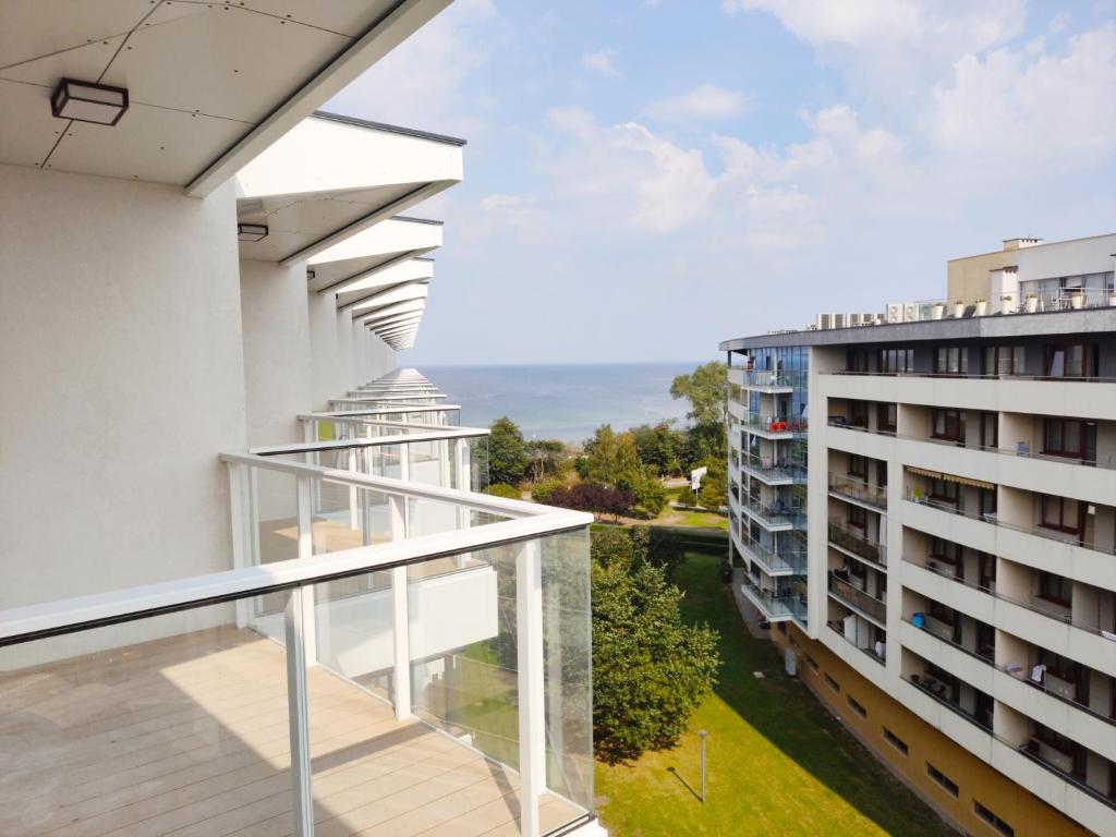 an apartment balcony with a view of a building at Seaside Park Private Apartment by Villmaris in Kołobrzeg