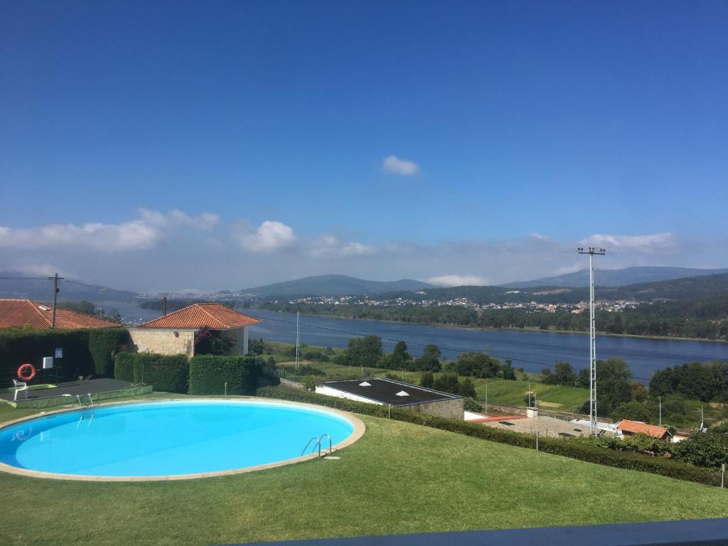 a swimming pool with a view of the water at Montanha, rio e mar... in Vila Nova de Cerveira