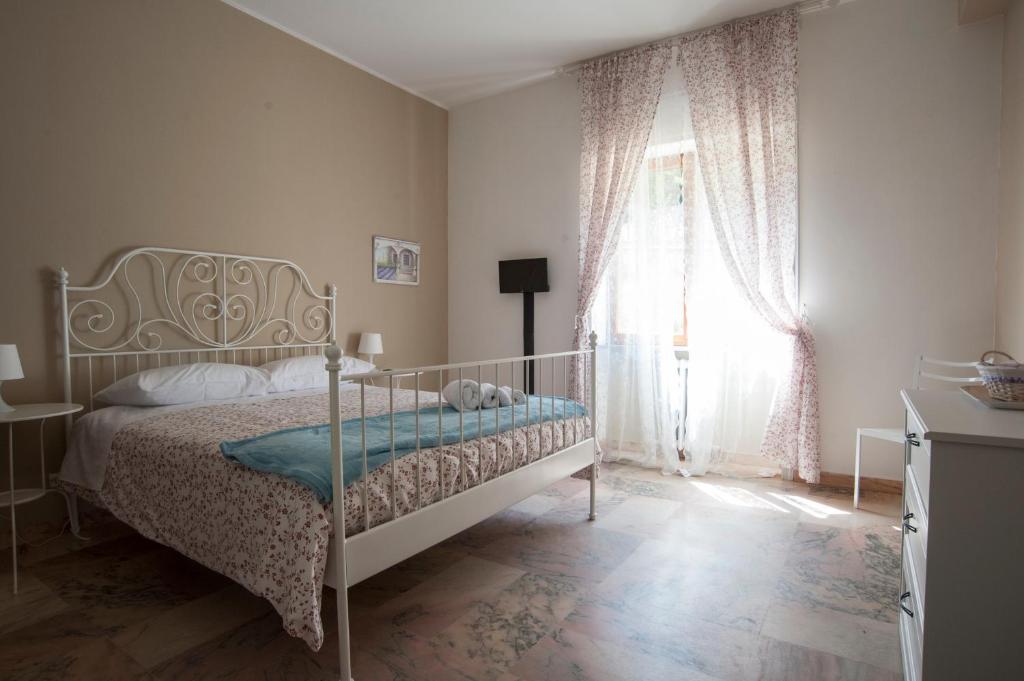 a bedroom with a bed and a large window at B&B Le Ortensie in Cosenza