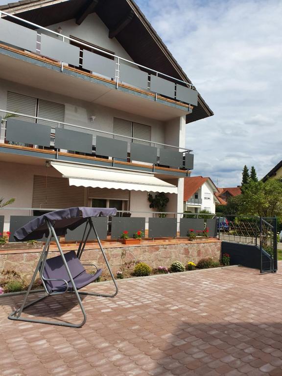 a chair sitting in front of a house at SUNSHINE Apartments Rust-Ringsheim in Ringsheim