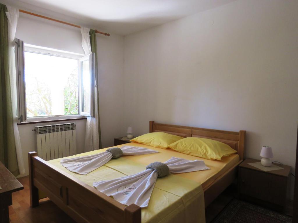 Postel nebo postele na pokoji v ubytování Apartments Palma Novalja