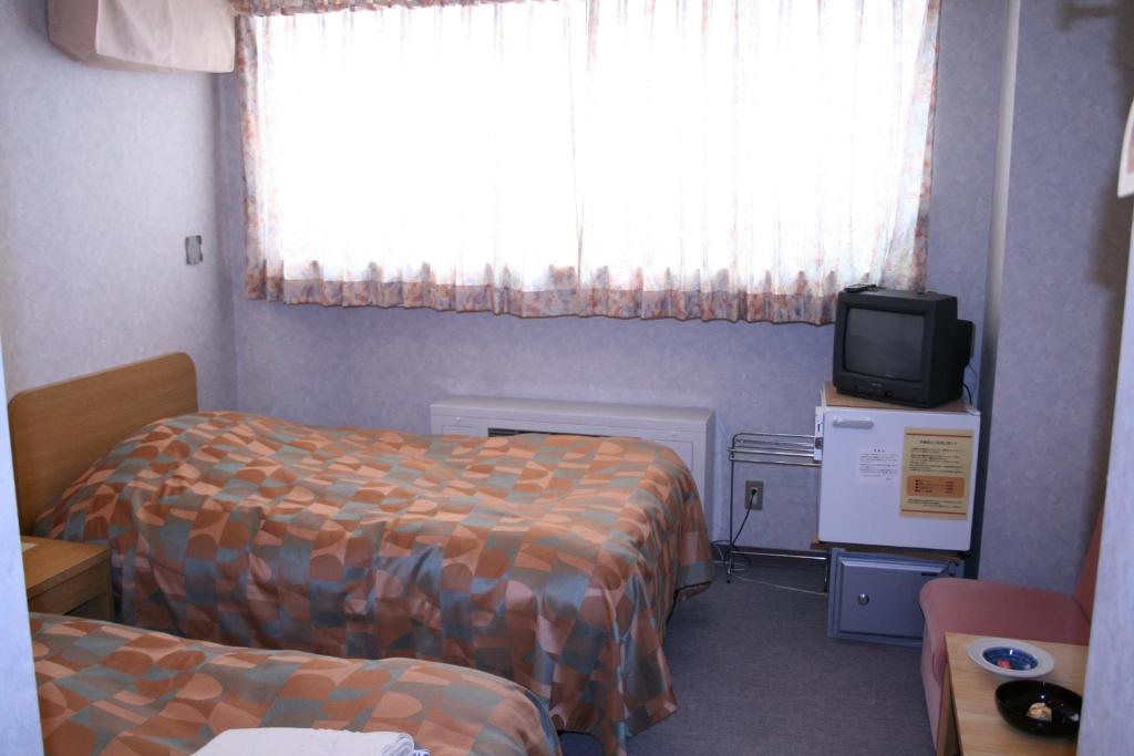 Postel nebo postele na pokoji v ubytování Akakura Wakui Hotel