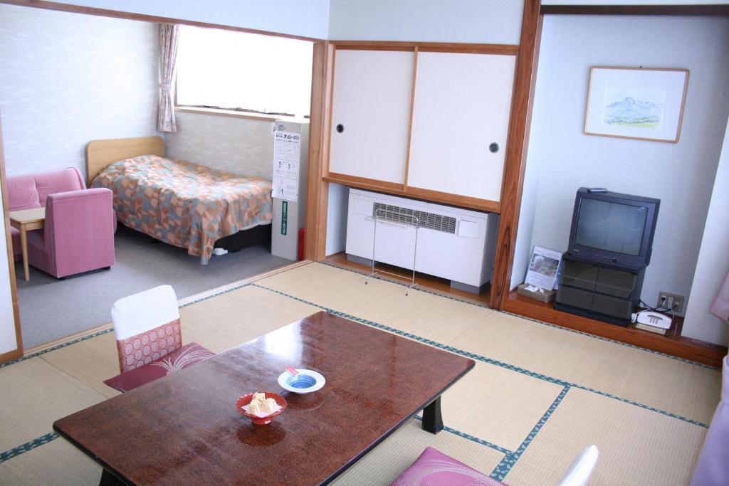 Postel nebo postele na pokoji v ubytování Akakura Wakui Hotel