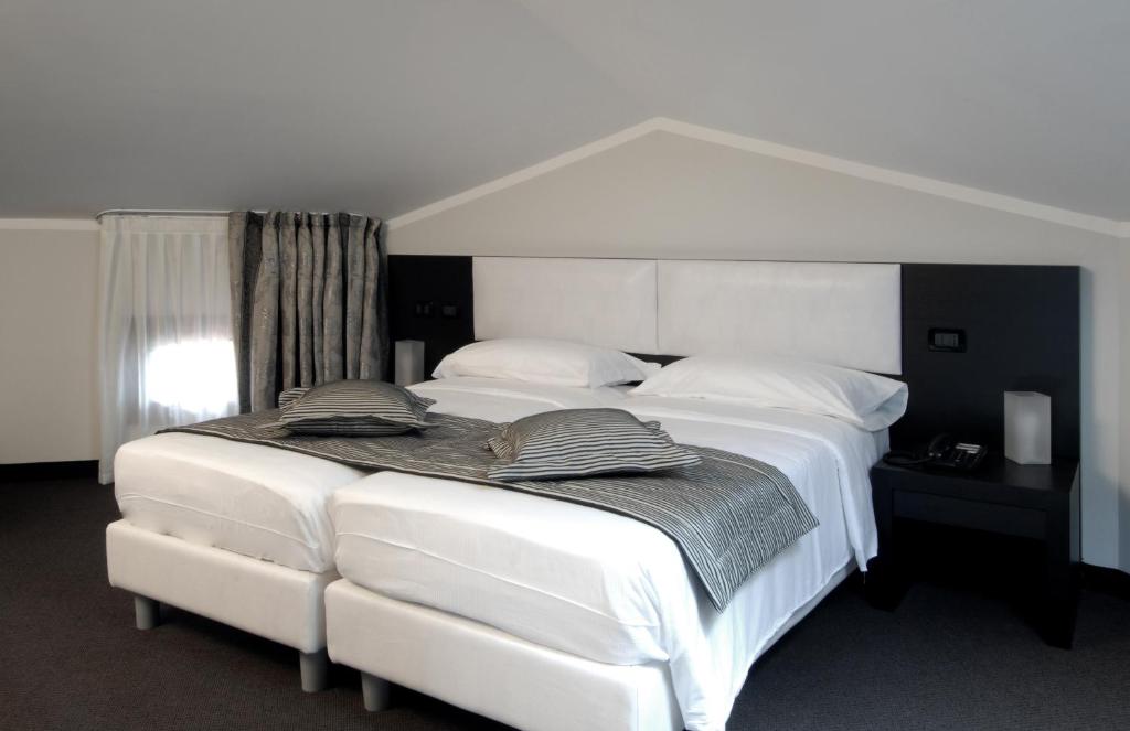 Postel nebo postele na pokoji v ubytování Hotel Villa Pannonia
