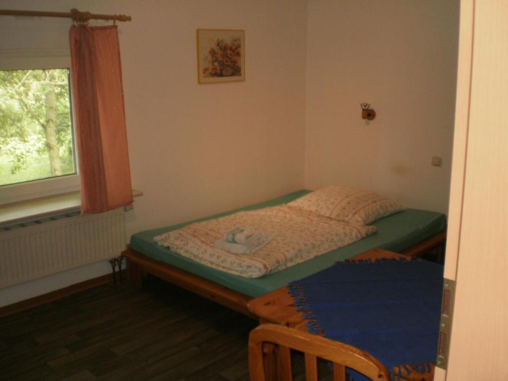 a small bedroom with a bed and a window at Herzberg in Kleve