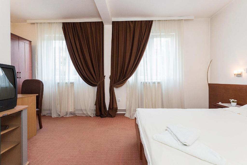 Postel nebo postele na pokoji v ubytování Hotel Dominus