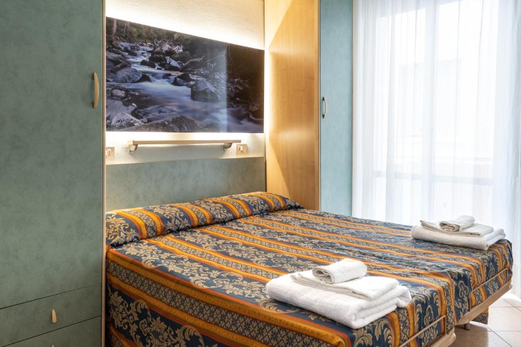 Postel nebo postele na pokoji v ubytování Hotel Tiglio