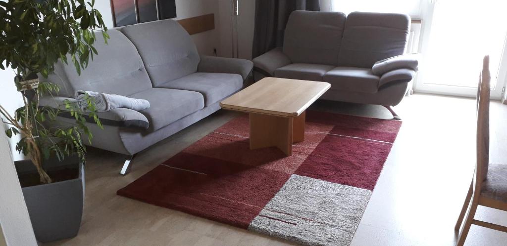 a living room with a couch and a coffee table at Gästehaus Tarmann in Annenheim