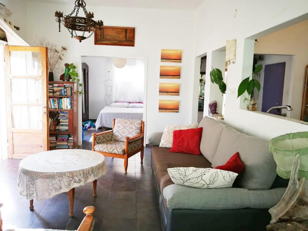 a living room with a couch and a table at Sea View Urban Oasis in Tel Aviv