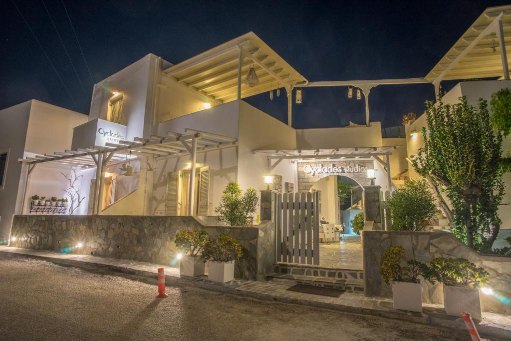 a white house with a gate at night at Cyclades Studios in Parikia