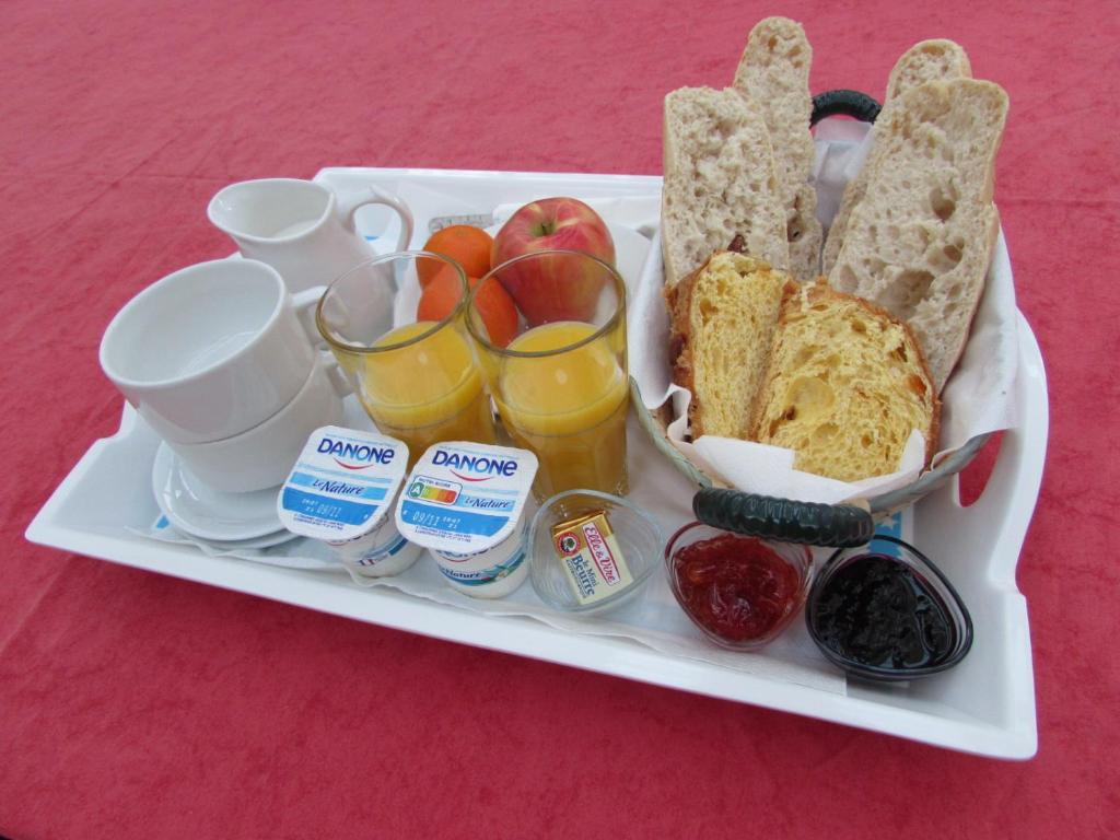 a tray of food with bread and fruit and drinks at Résidence Royal Palmeraie in Aubagne
