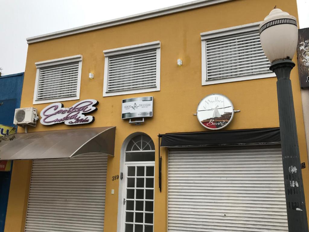 a building with a clock on the side of it at Imperial 2 Calçadão in Cornélio Procópio