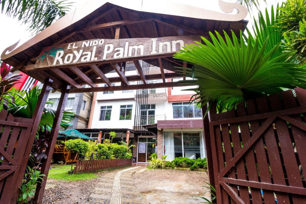 a sign for a pool pain inn in front of a building at El Nido Royal Palm Inn in El Nido