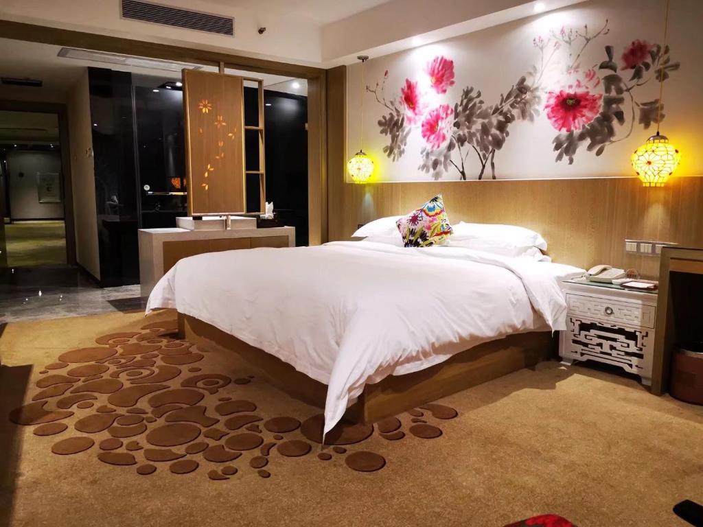 Postel nebo postele na pokoji v ubytování Paco Hotel Beijing Road Tuan Yi Da Metro Guangzhou