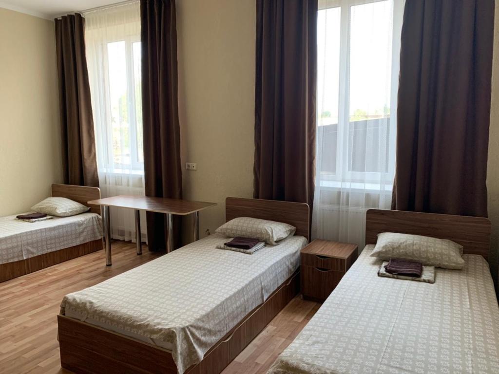 Postel nebo postele na pokoji v ubytování Monada Hotel & Hostel