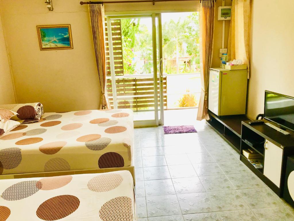 Postel nebo postele na pokoji v ubytování Thanorm Rak Resort