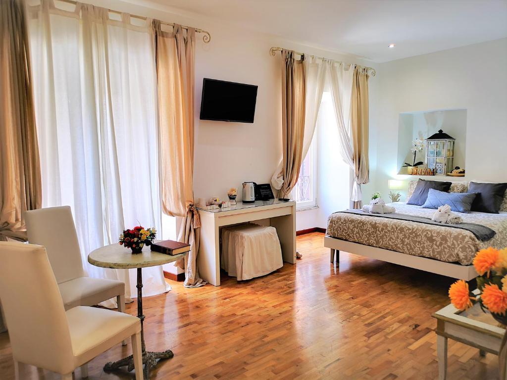 a bedroom with a bed and a table and chairs at Have A Nice Holiday - Luxury Rooms in Rome