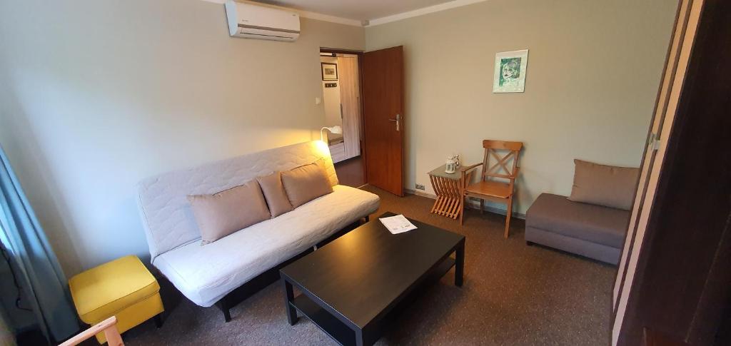 a living room with a couch and a coffee table at Apartament RSL in Ruda Śląska