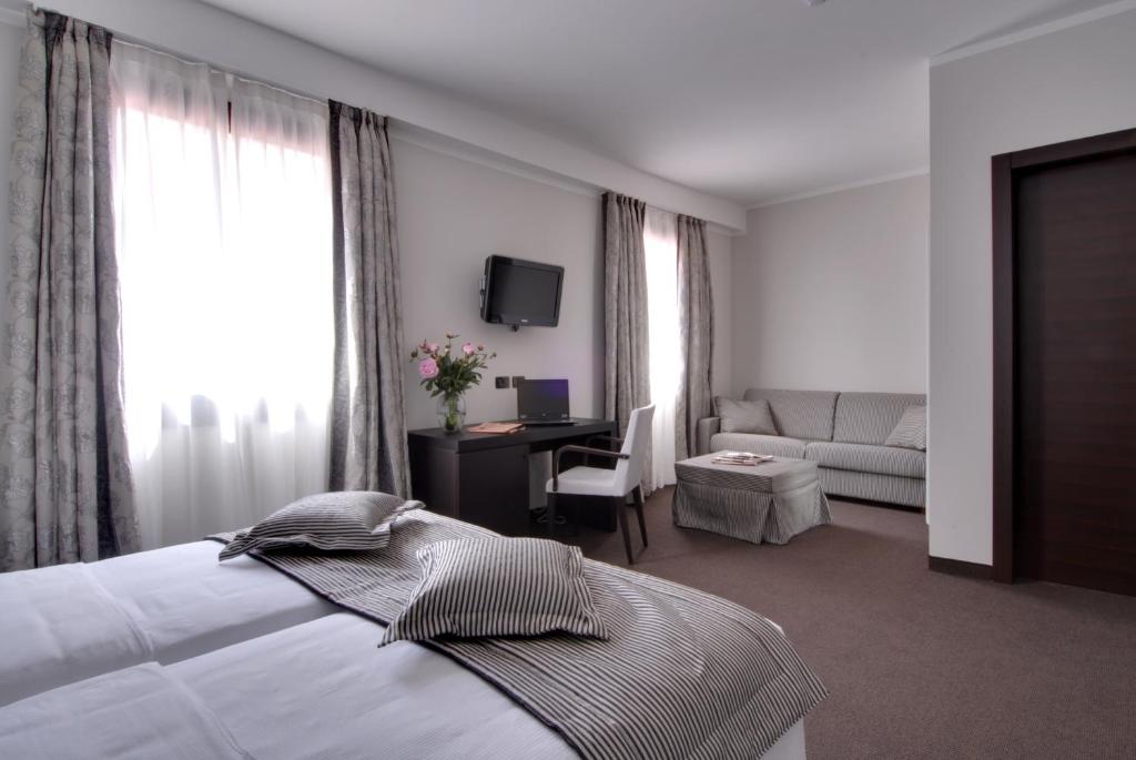 Postel nebo postele na pokoji v ubytování Hotel Villa Pannonia