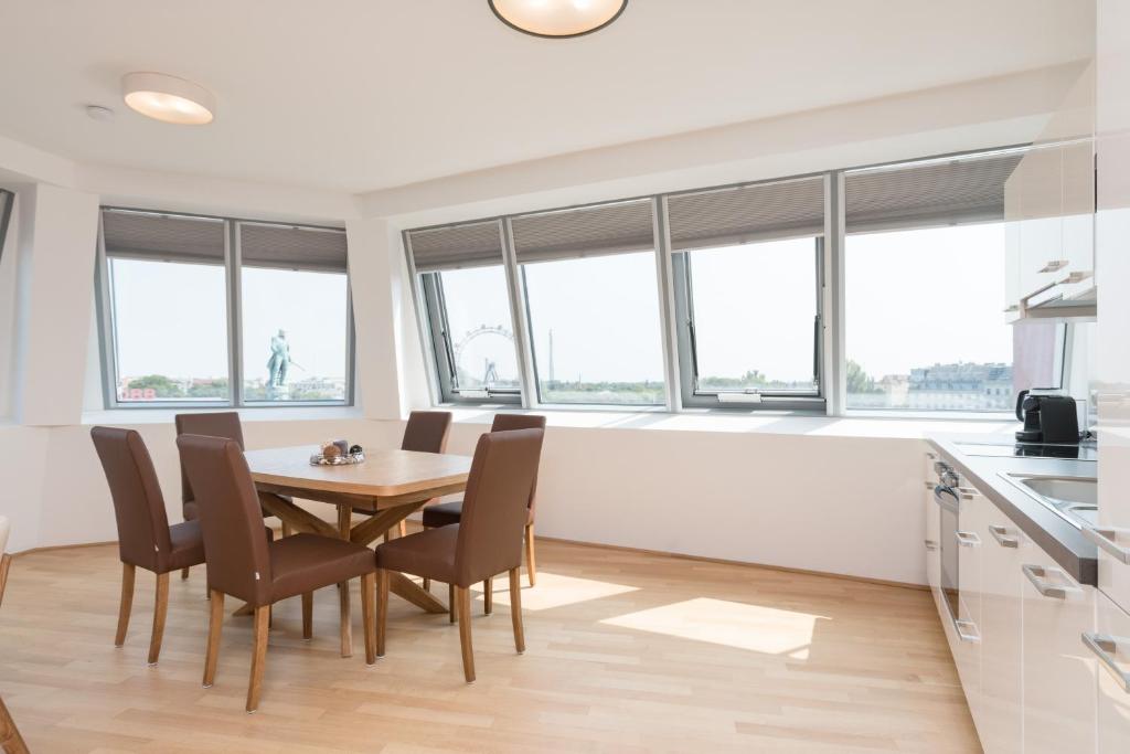 a kitchen and dining room with a table and chairs at Yourapartment Prater in Vienna